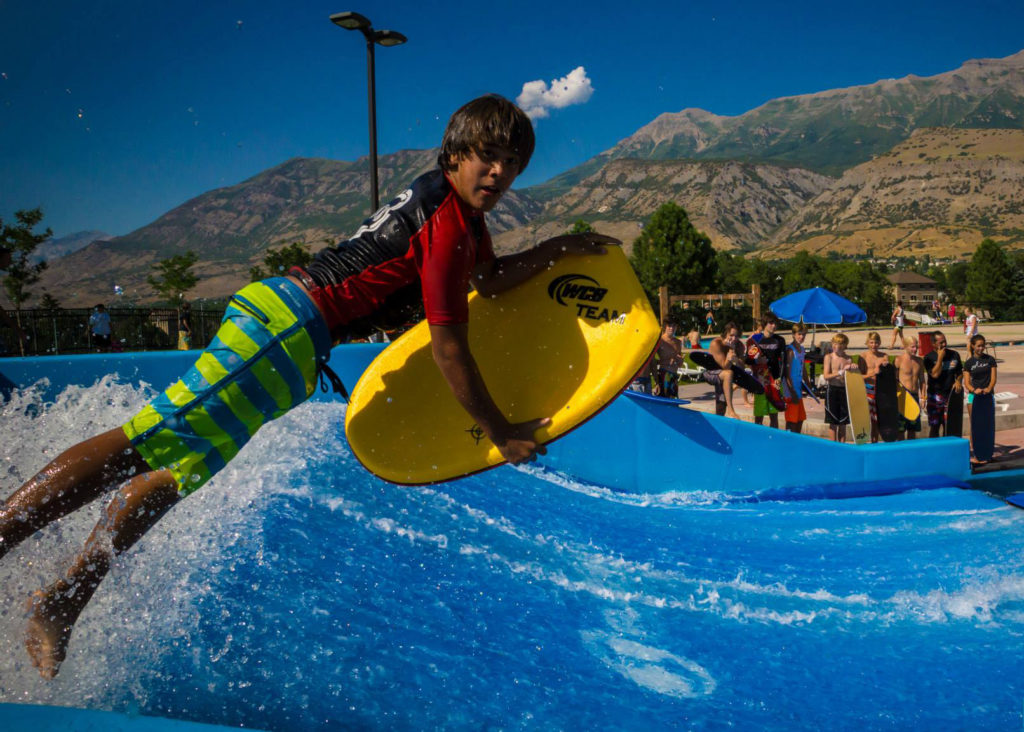 Bodyboarder jumping onto a FlowRider