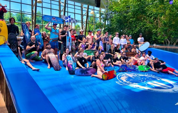 A large group of people standing on a FlowRider