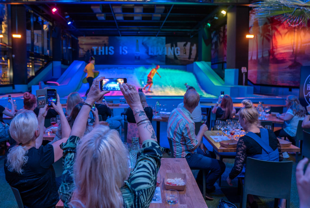 People watching person on flowrider