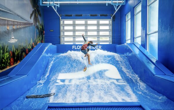 Flowboarder doing a trick on a FlowRider Single wave machine at the Surf Style in Marathon Florida Keys
